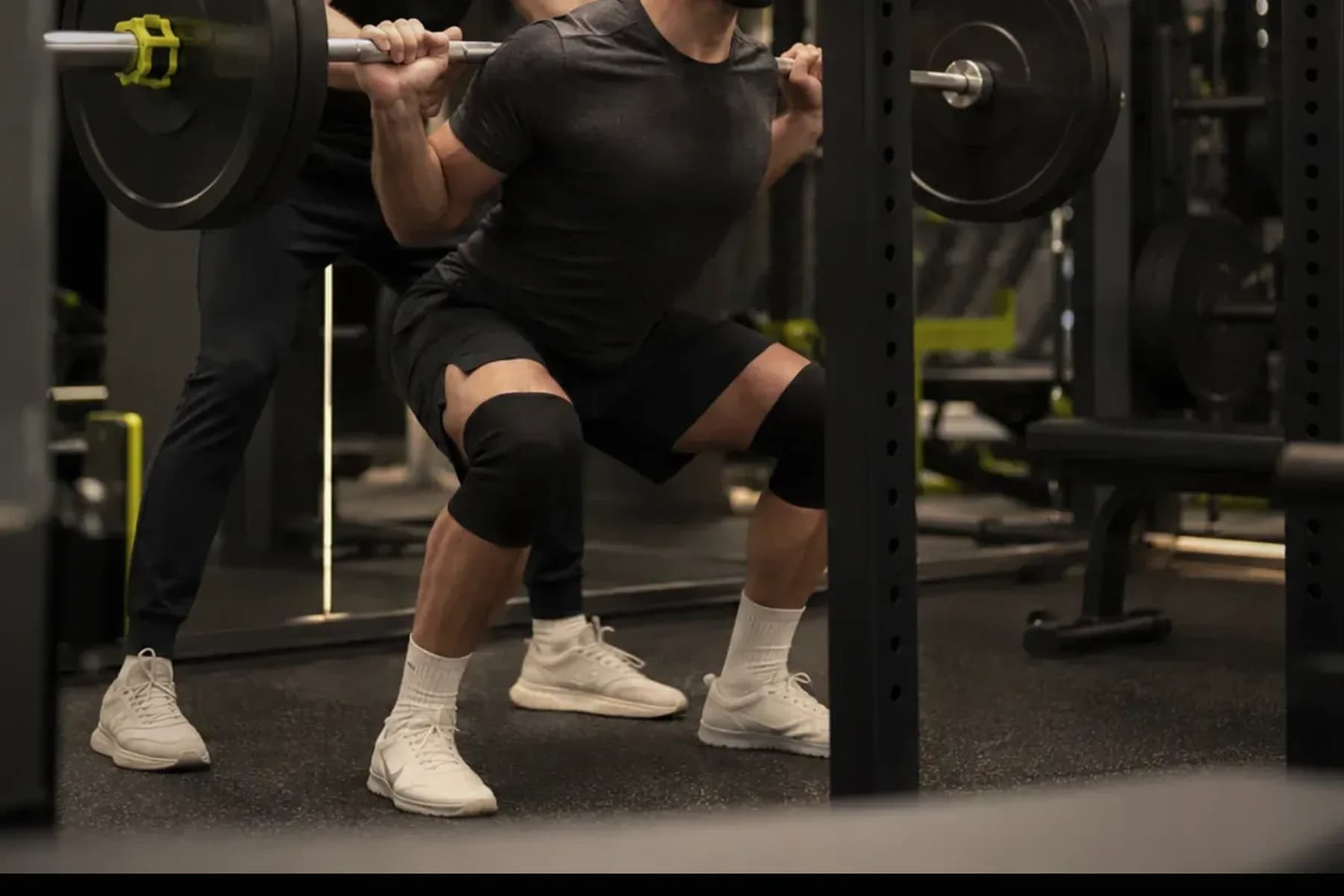 Close detail of a coached strength session on the FORGE training floor